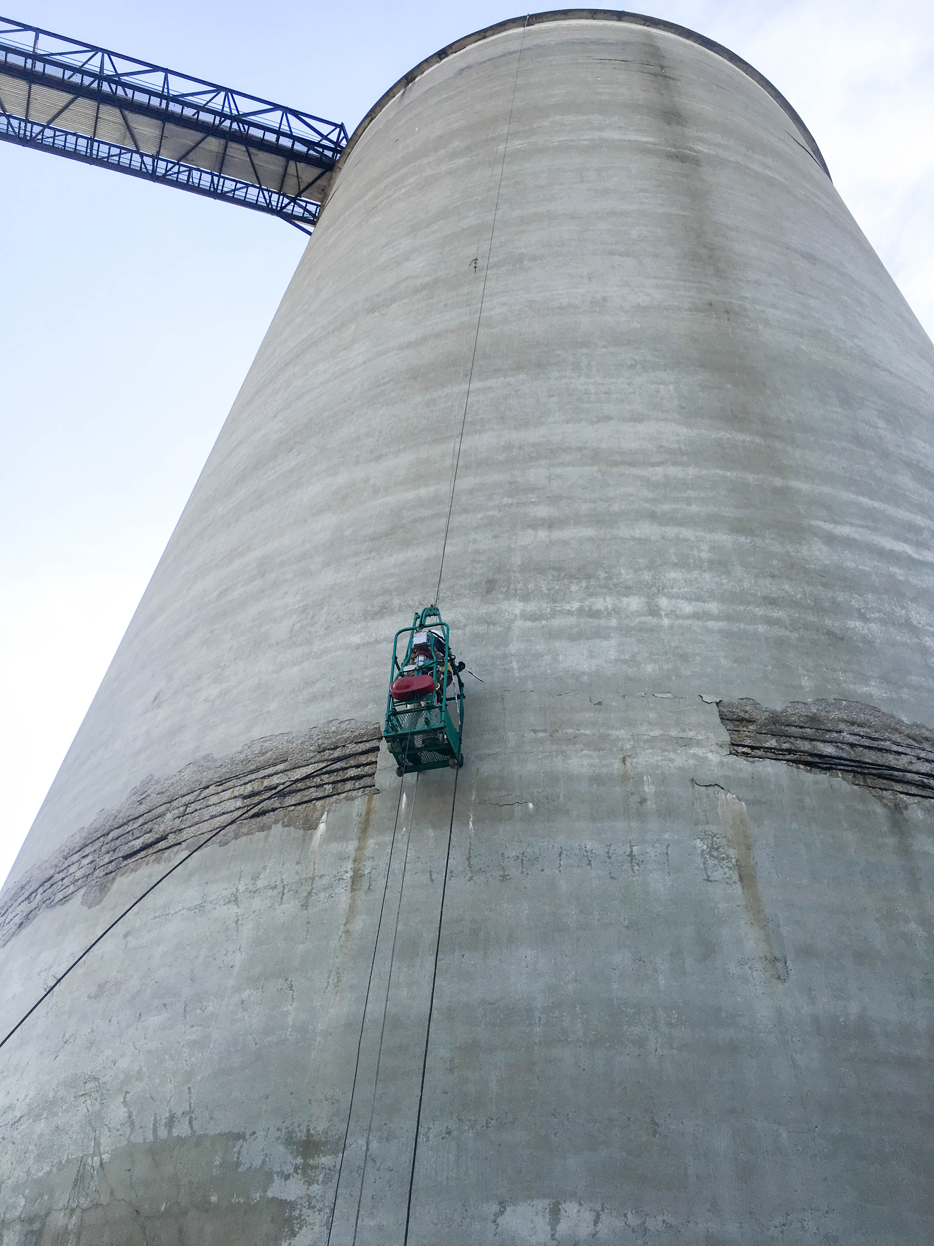Man on side of silo performing silo inspection