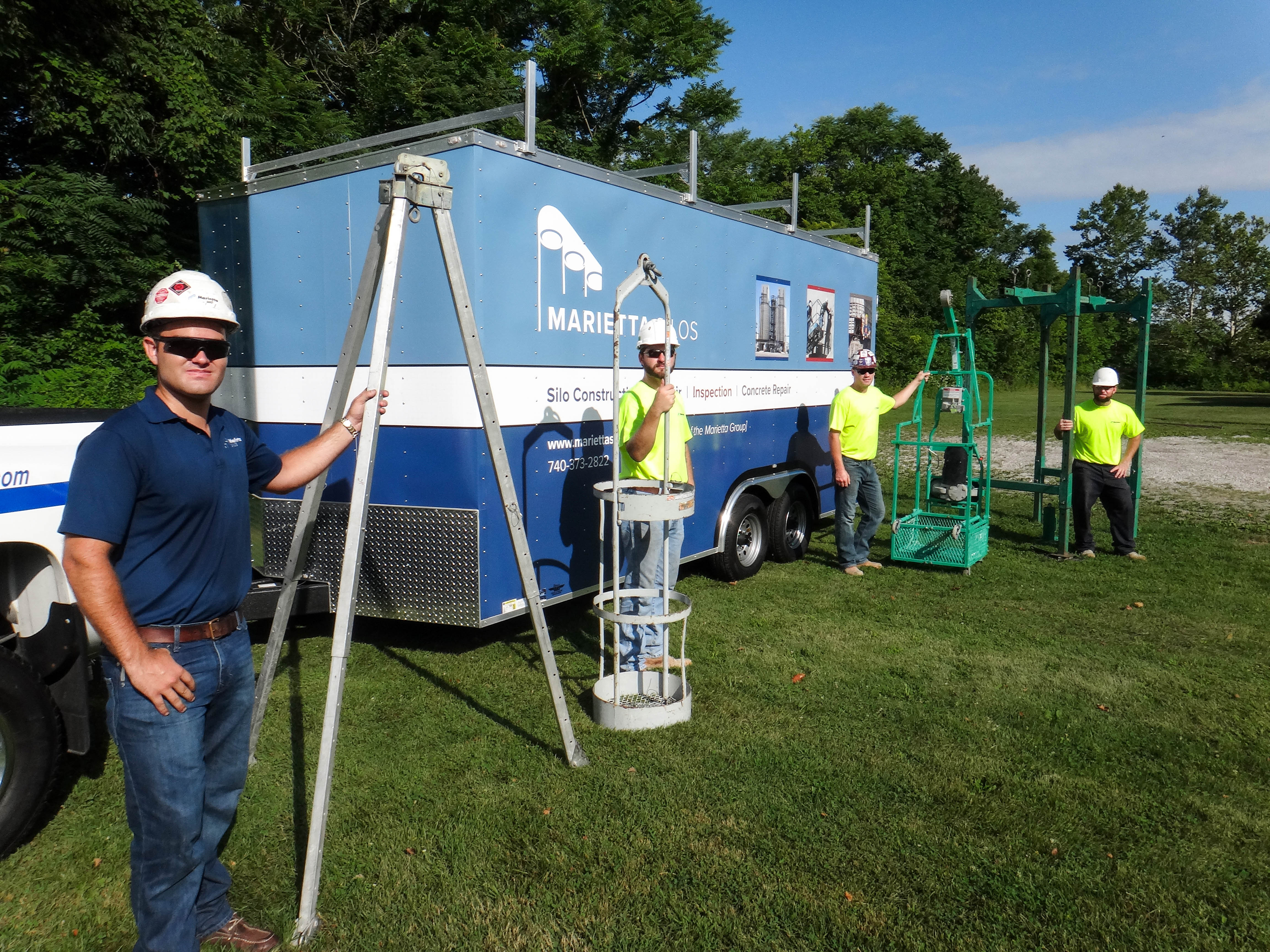 Crew standing by mobile silo inspection trailer